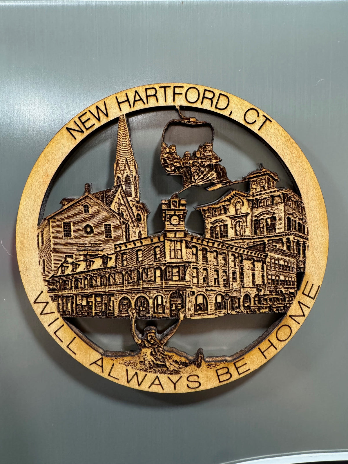 New Hartford, CT wooden refrigerator magnet featuring historic buildings, a ski lift, and a farmington river tuber.