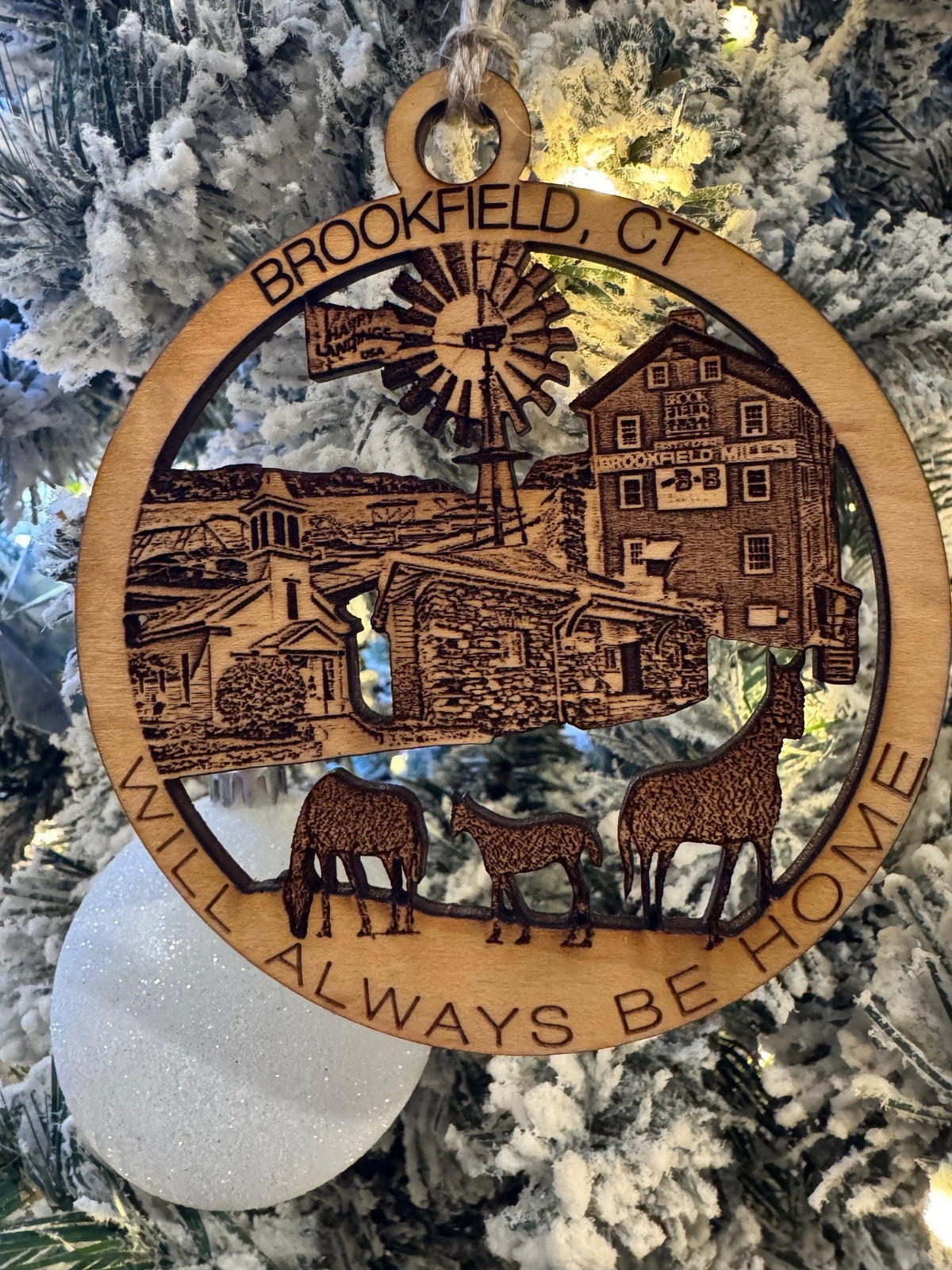 Brookfield, CT Christmas ornament featuring Brookfield Mills, a windmill, historic buildings, and grazing animals.