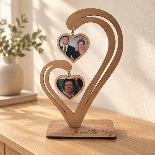 Freestanding wooden memorial photo heart with two family photos displayed on a console table