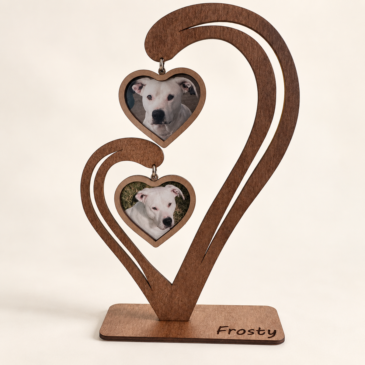 Personalized wooden pet memorial heart displaying two photos of a white dog and Frosty engraved on the base